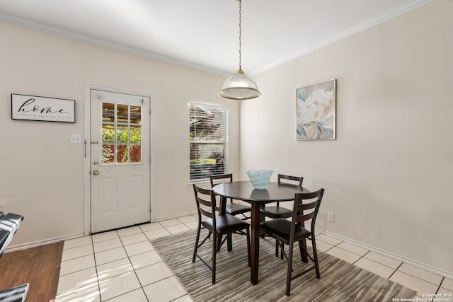 dining room featuring light tile patterned flooring and crown molding