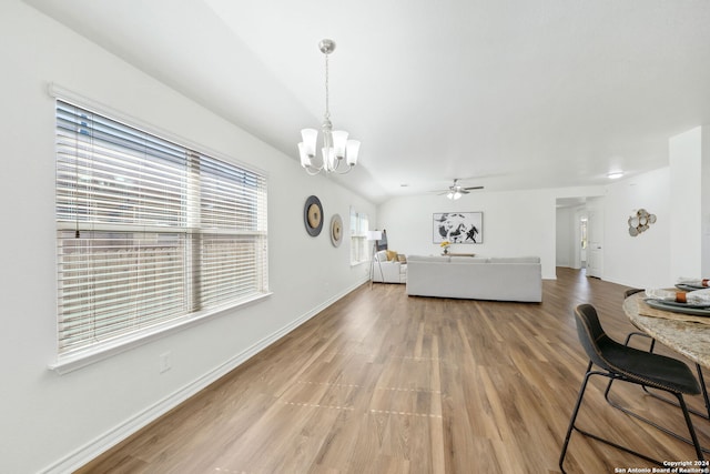 interior space with hardwood / wood-style floors and ceiling fan with notable chandelier