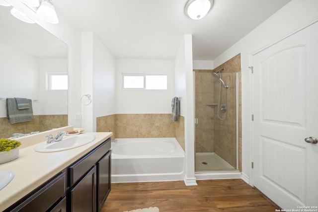 bathroom featuring plenty of natural light, vanity, shower with separate bathtub, and hardwood / wood-style flooring