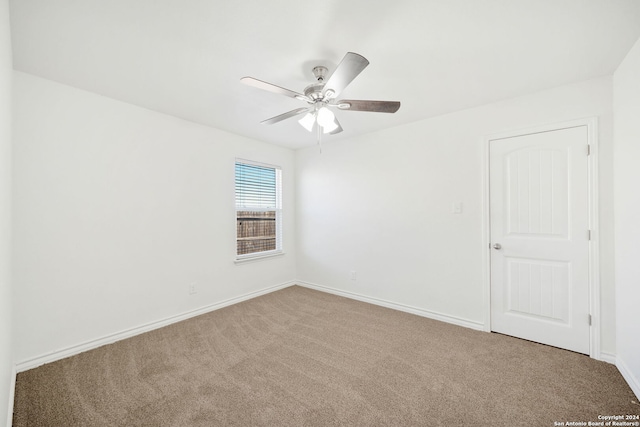 empty room with carpet flooring and ceiling fan