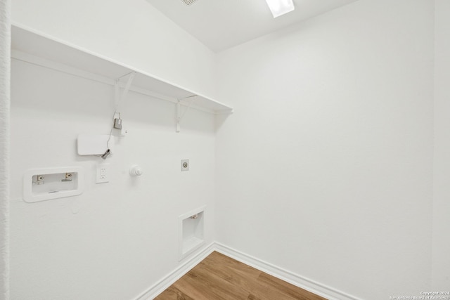 clothes washing area with hardwood / wood-style floors, hookup for a gas dryer, hookup for a washing machine, and electric dryer hookup