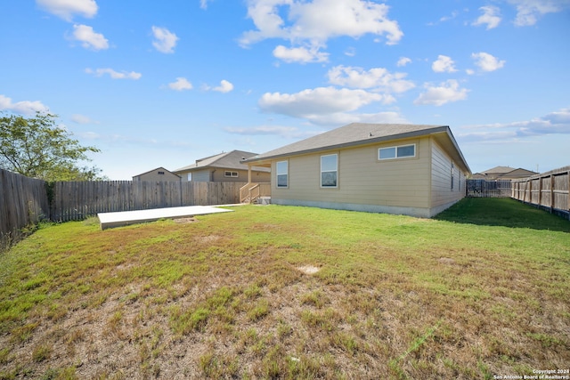 back of property featuring a patio and a lawn