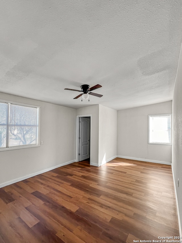 unfurnished room featuring hardwood / wood-style floors, a textured ceiling, and ceiling fan