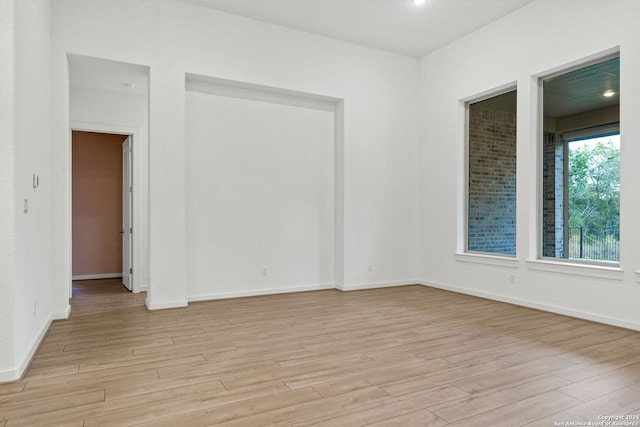 unfurnished room with light wood-type flooring