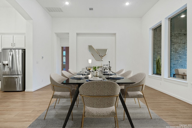 dining room with a wealth of natural light and light hardwood / wood-style flooring