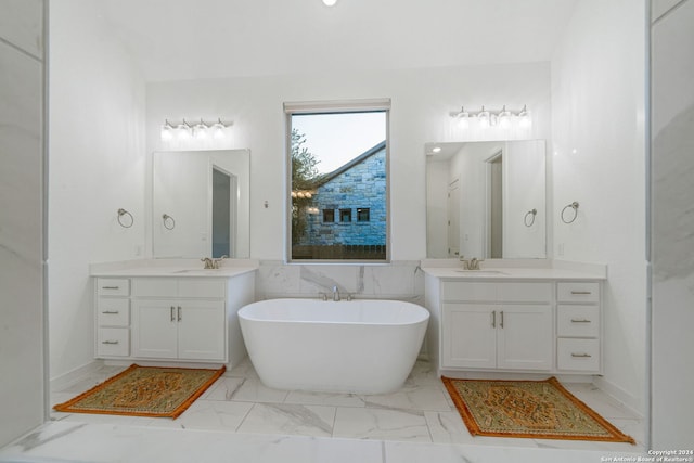 bathroom featuring a bathing tub, vanity, and tile walls