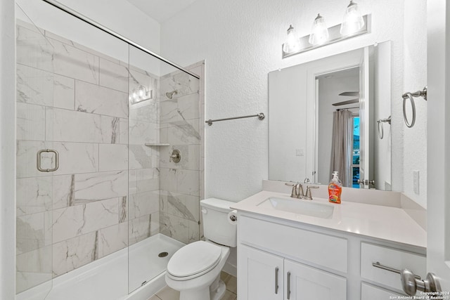 bathroom featuring vanity, toilet, and a shower with shower door