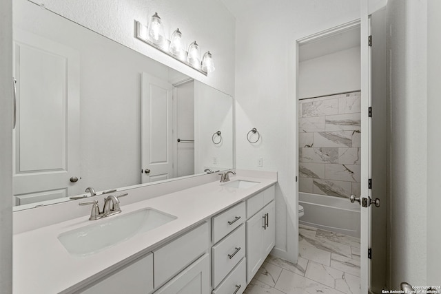 full bathroom featuring vanity, toilet, and tiled shower / bath