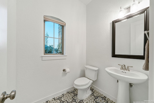 bathroom featuring tile patterned flooring and toilet