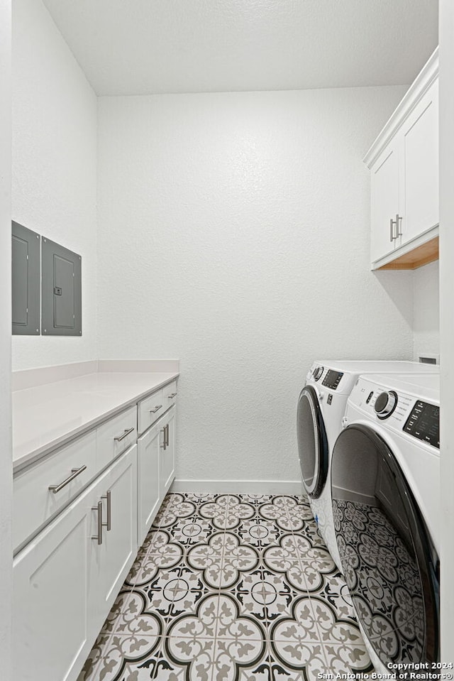 washroom featuring cabinets and independent washer and dryer