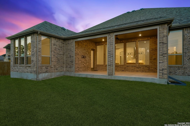 back house at dusk with a yard