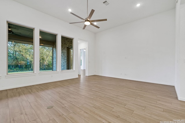 empty room featuring ceiling fan and light hardwood / wood-style flooring