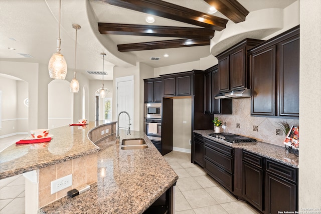 kitchen featuring stainless steel appliances, a spacious island, sink, pendant lighting, and beamed ceiling