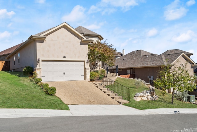 view of front of house with a garage, a front lawn, and cooling unit