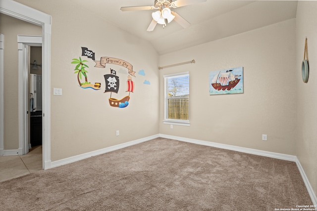 unfurnished room featuring ceiling fan, light colored carpet, and vaulted ceiling