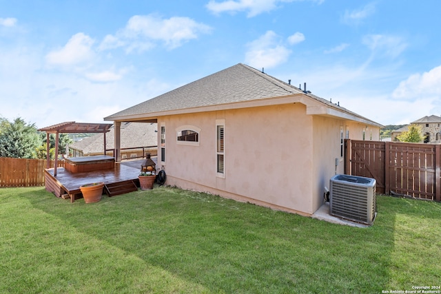 back of property featuring central AC and a lawn