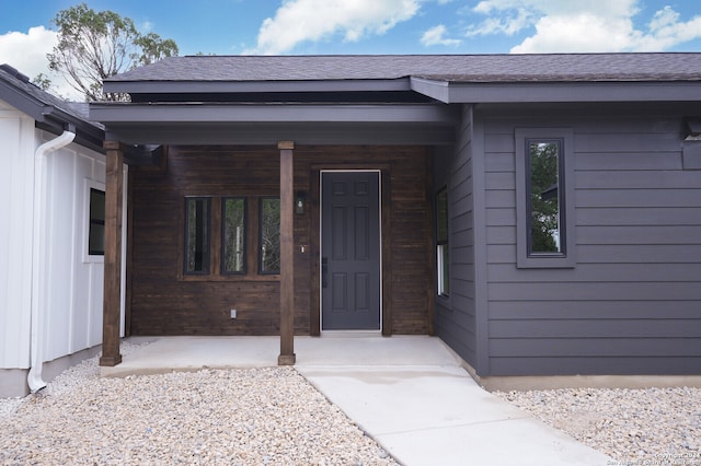 view of exterior entry featuring a porch