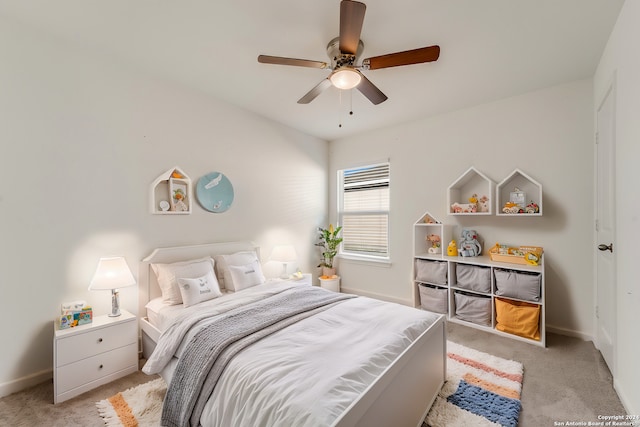 bedroom featuring light colored carpet and ceiling fan