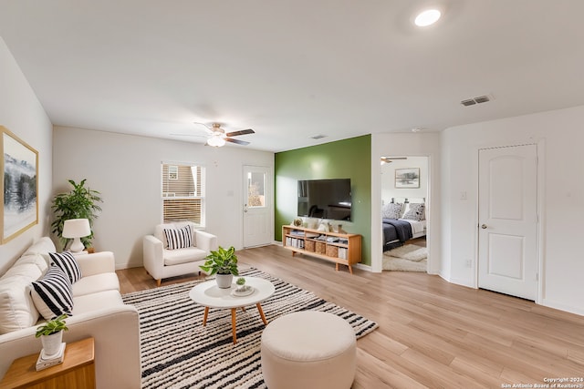 living room with ceiling fan and light hardwood / wood-style floors