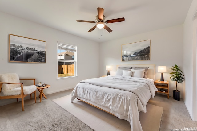 bedroom with light carpet and ceiling fan