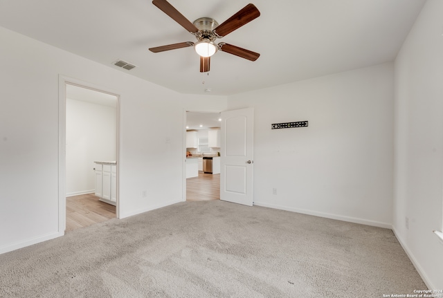 unfurnished bedroom with ceiling fan and light colored carpet