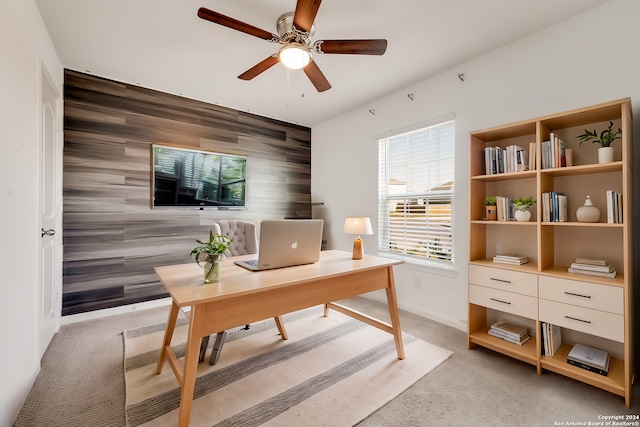 office with wooden walls and ceiling fan