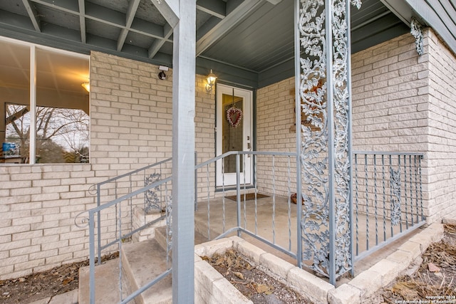 view of exterior entry with covered porch