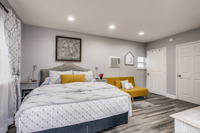 bedroom featuring a wall unit AC and hardwood / wood-style floors