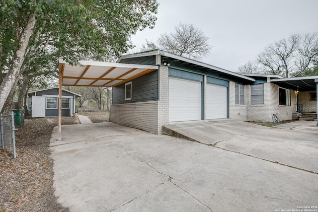 6531 Fox Run, San Antonio, TX 78233 - view of front of property featuring brick siding, concrete driveway, a storage unit, and an attached garage