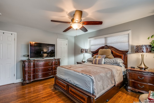 bedroom featuring ceiling fan and dark wood-type flooring