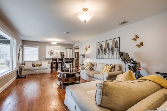 living room with hardwood / wood-style floors and a chandelier