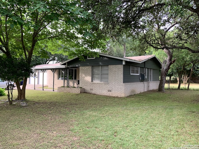 view of side of property with a yard and a garage