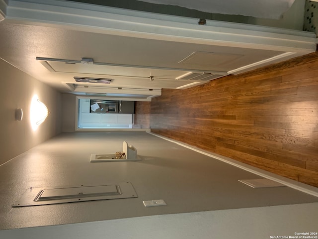 hallway featuring wood walls