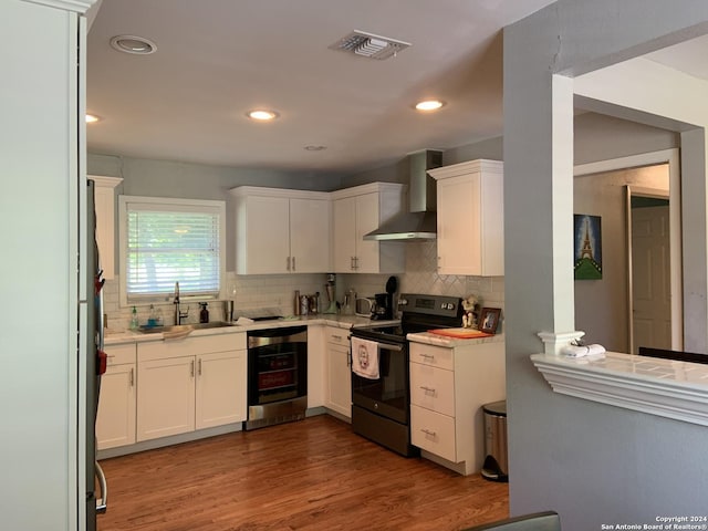 6531 Fox Run, San Antonio, TX 78233 - kitchen featuring electric range, wall chimney range hood, dishwashing machine, tasteful backsplash, and recessed lighting