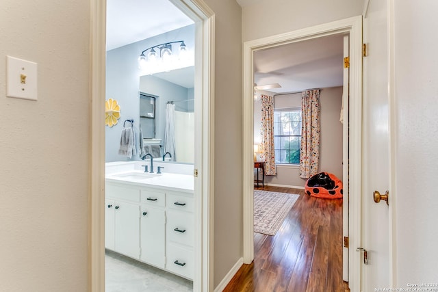 hall featuring sink and light hardwood / wood-style floors