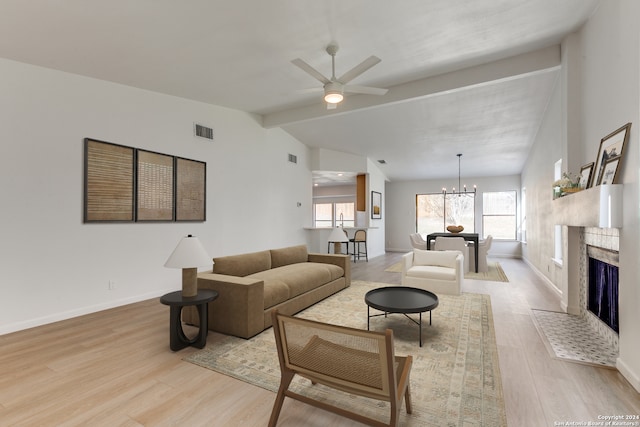 living room with vaulted ceiling with beams, ceiling fan with notable chandelier, and light hardwood / wood-style flooring