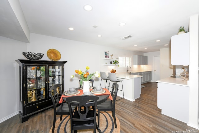 dining area featuring dark hardwood / wood-style flooring and sink