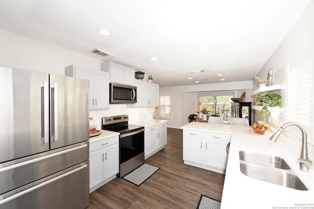 kitchen featuring sink, white cabinets, and appliances with stainless steel finishes