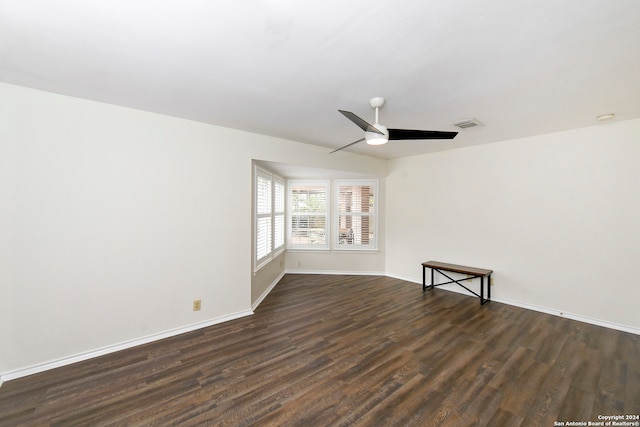 empty room with dark hardwood / wood-style floors and ceiling fan