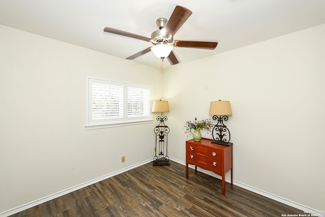 spare room with dark hardwood / wood-style flooring and ceiling fan