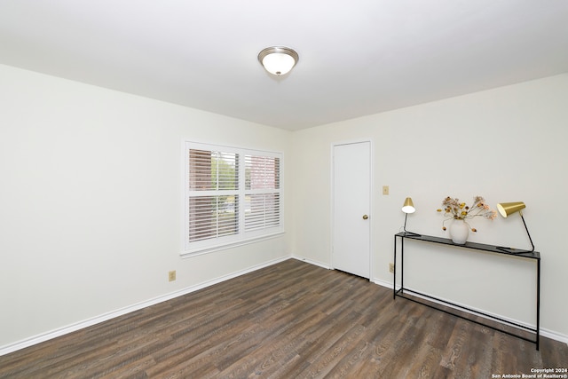 unfurnished room with dark hardwood / wood-style floors