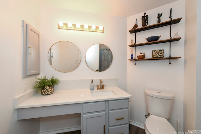 bathroom featuring vanity and toilet