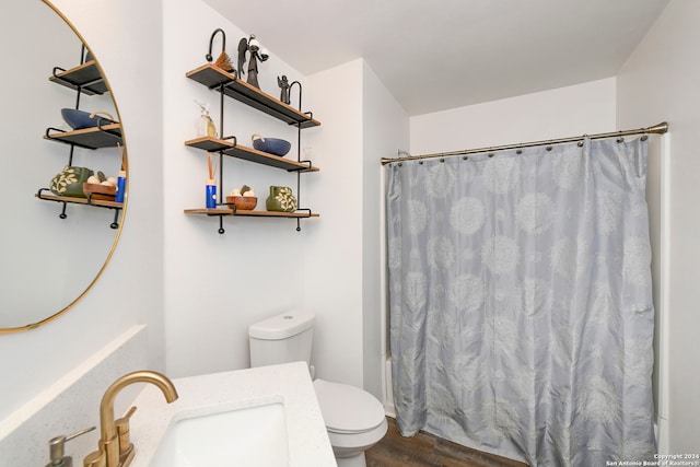 full bathroom with shower / bathtub combination with curtain, hardwood / wood-style floors, vanity, and toilet