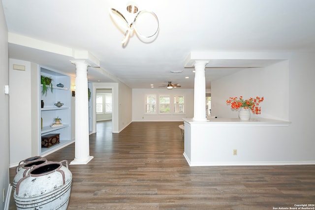 living room with decorative columns, ceiling fan, and dark hardwood / wood-style floors