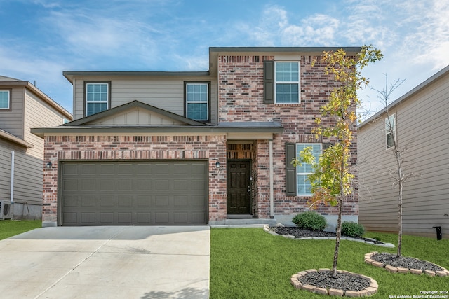 view of front of property with a front yard and a garage