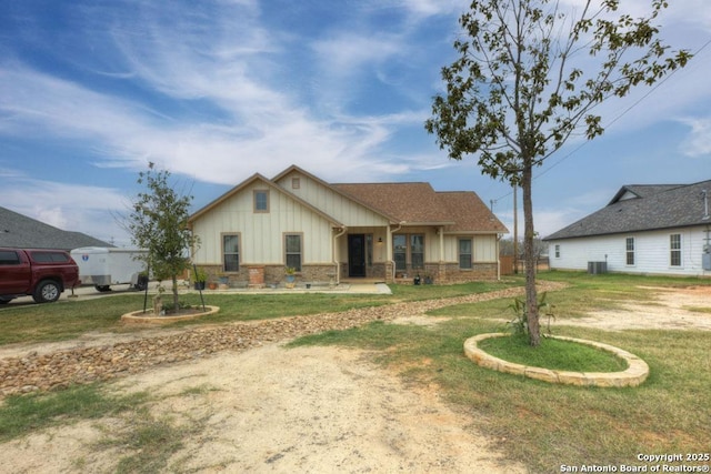 view of front of property featuring central AC and a front lawn