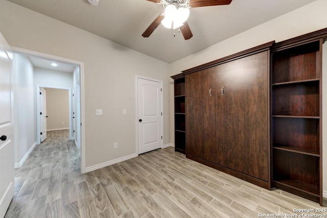 unfurnished bedroom featuring light wood-type flooring and ceiling fan