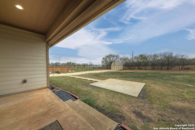 view of yard featuring a patio and a shed