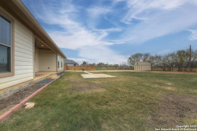 view of yard featuring a patio and a storage unit