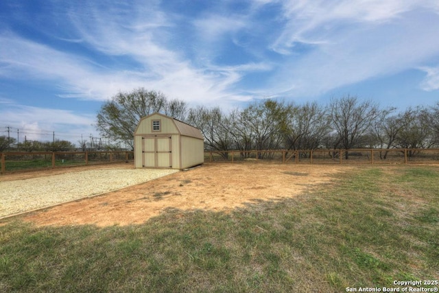 view of yard featuring a rural view and a storage unit